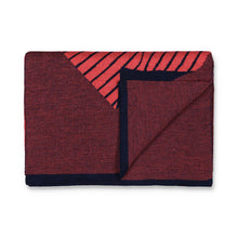 Load image into Gallery viewer, Flatlay of folded striped knit scarf in coral pink and dark blue.
