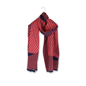 Packshot of a knit striped scarf in coral pink and dark blue.