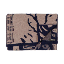 Load image into Gallery viewer, Flatlay of a jacquard knit scarf in dark indigo blue and beige. The scarf has a figurative pattern resembling trees in a forest.
